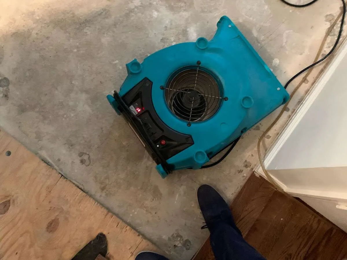 Air mover drying subfloor during Commercial Water Damage Restoration in Shelby